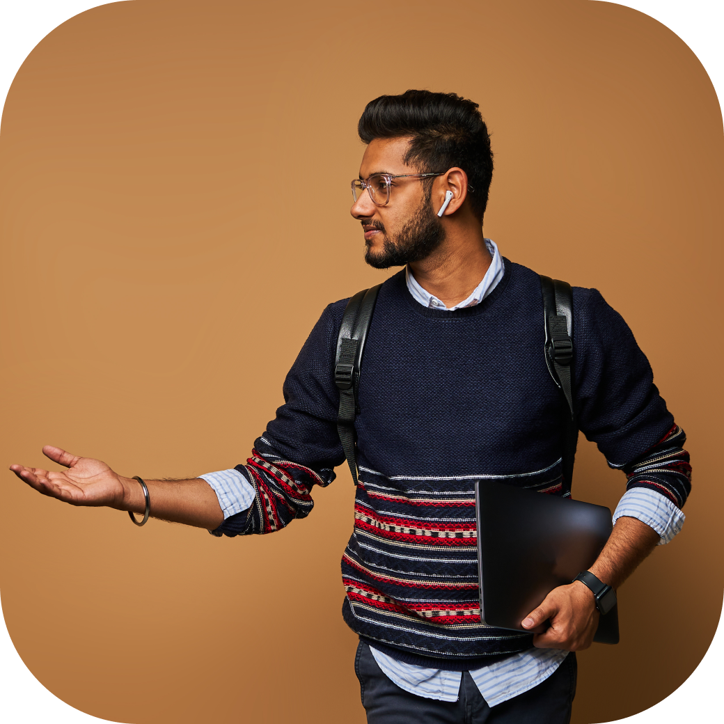 stylish-handsome-indian-student-with-laptop-backpack-pointiong-his-hand-wall 2